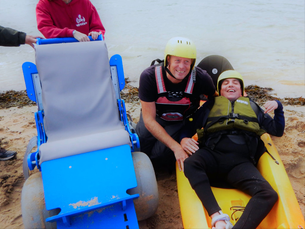 kayaker with coach and beach wheelchair
